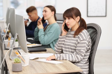 Photo of Sales department. People calling to clients in office, selective focus