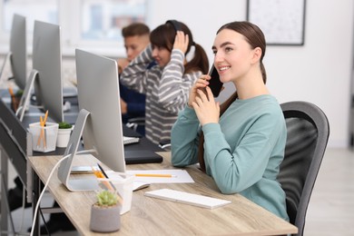 Photo of Sales department. People calling to clients in office, selective focus