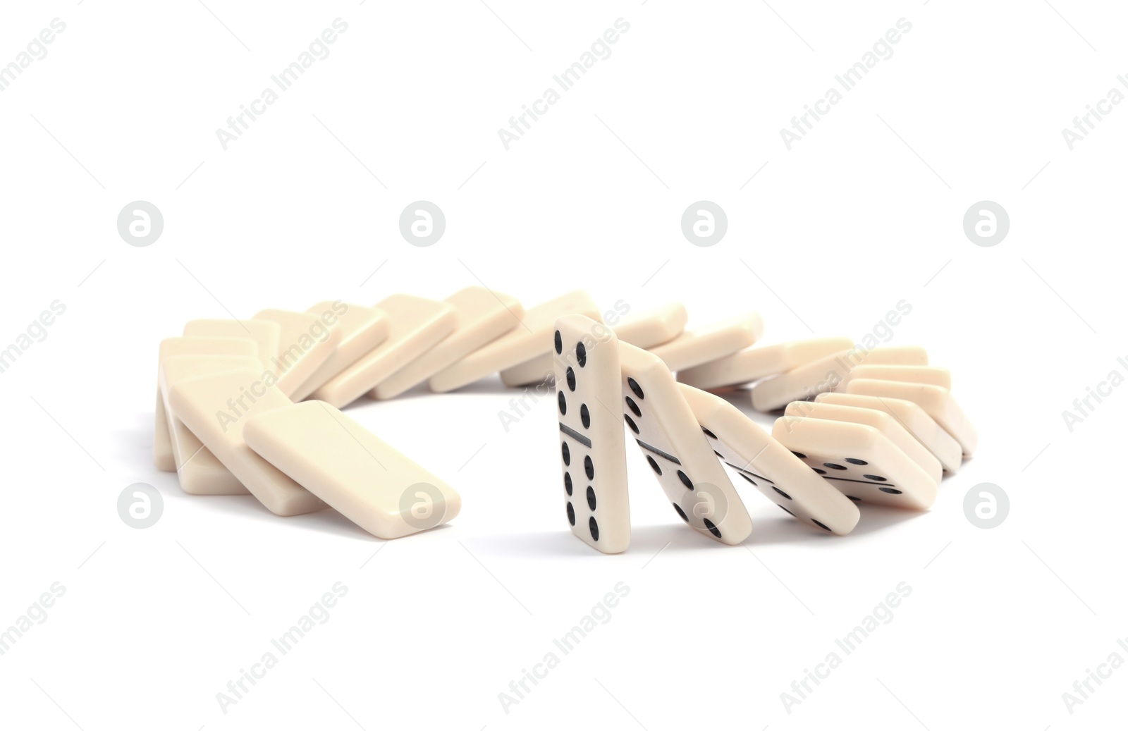 Photo of Domino effect. Tiles falling on white background