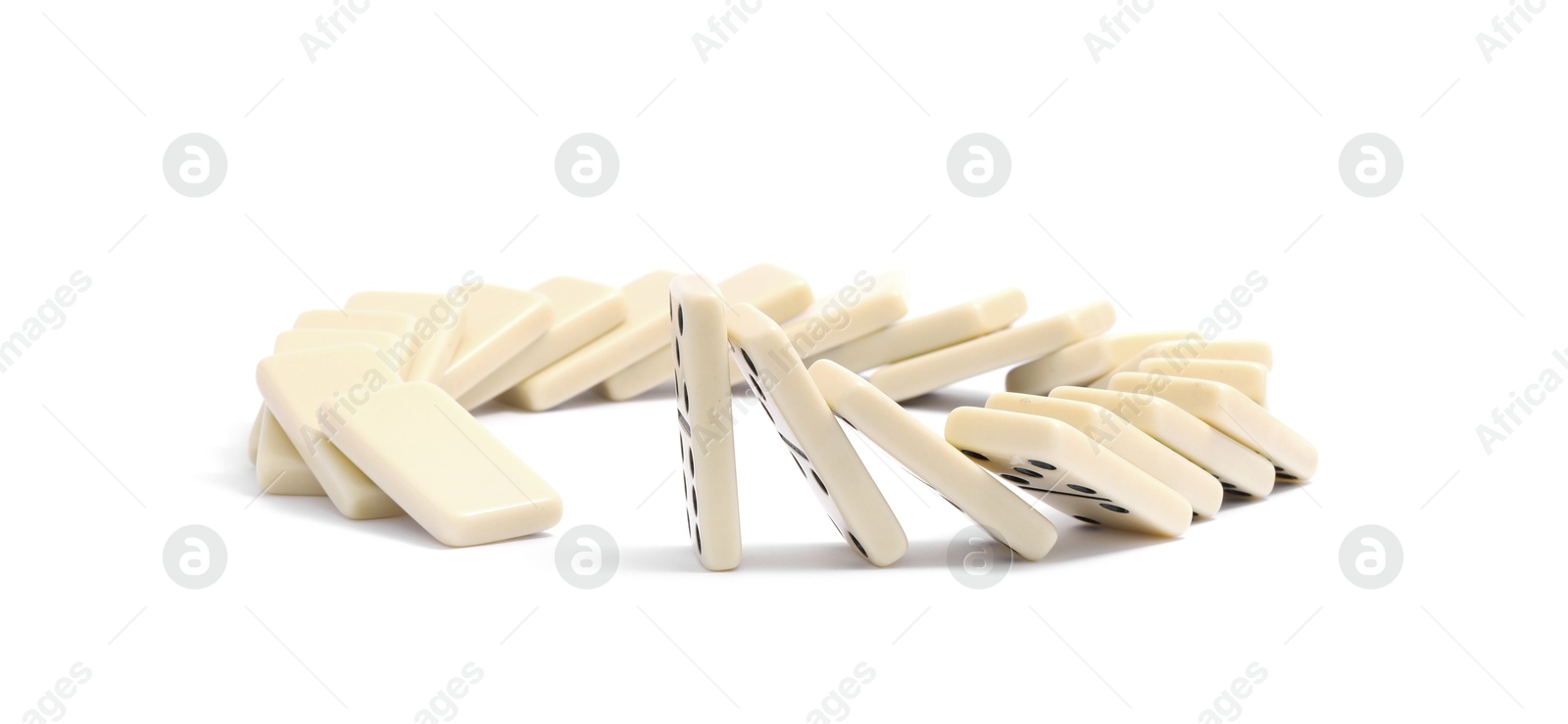 Photo of Domino effect. Tiles falling on white background