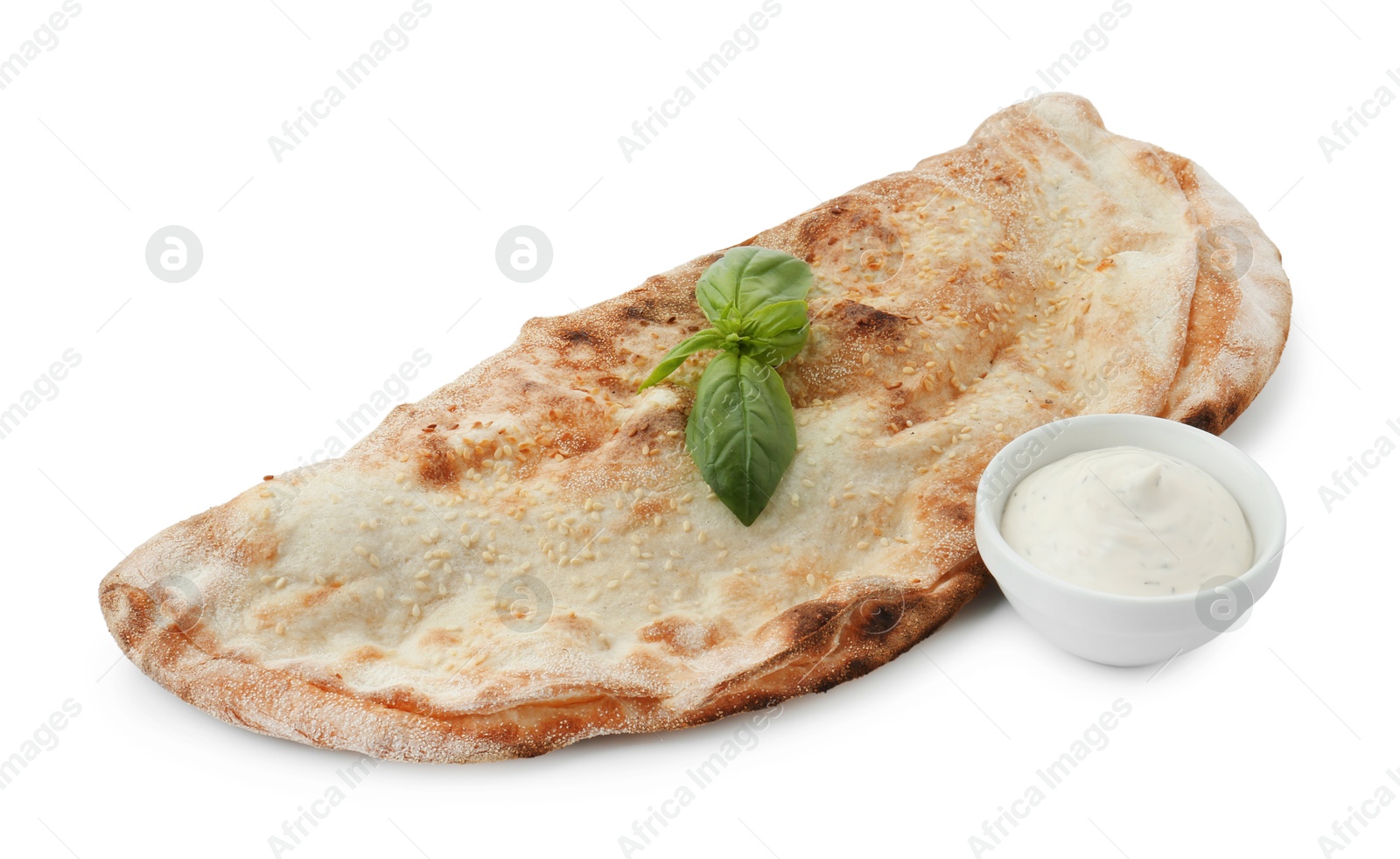 Photo of Delicious calzone with sauce and fresh basil isolated on white