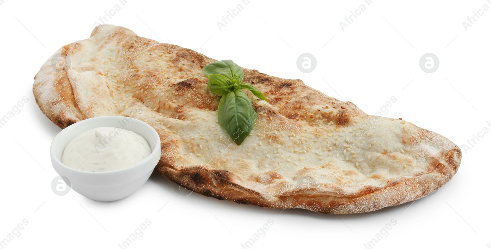 Photo of Delicious calzone with sauce and fresh basil isolated on white