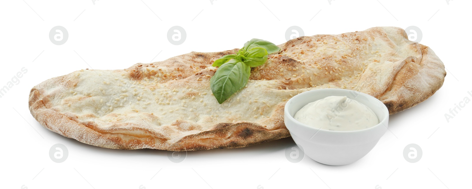 Photo of Delicious calzone with sauce and fresh basil isolated on white