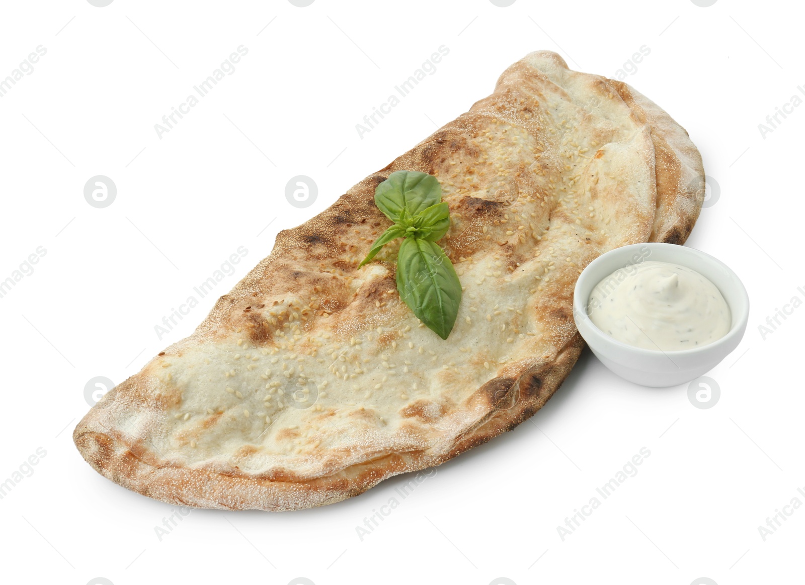 Photo of Delicious calzone with sauce and fresh basil isolated on white