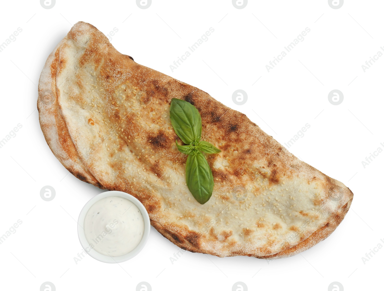 Photo of Delicious calzone with sauce and fresh basil isolated on white, top view