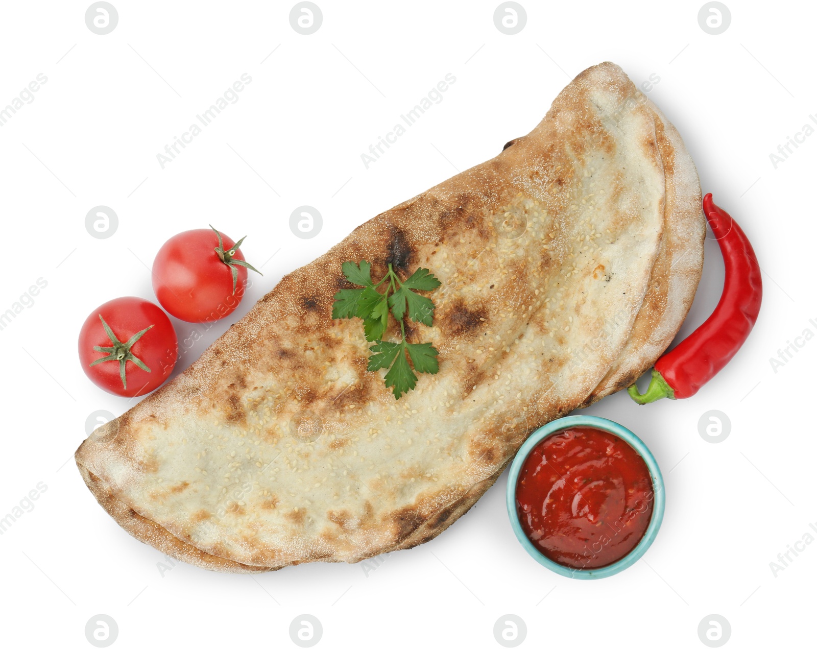 Photo of Delicious calzone with ketchup, fresh tomatoes and chili pepper isolated on white, top view