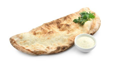 Photo of Delicious calzone with fresh parsley and sauce isolated on white