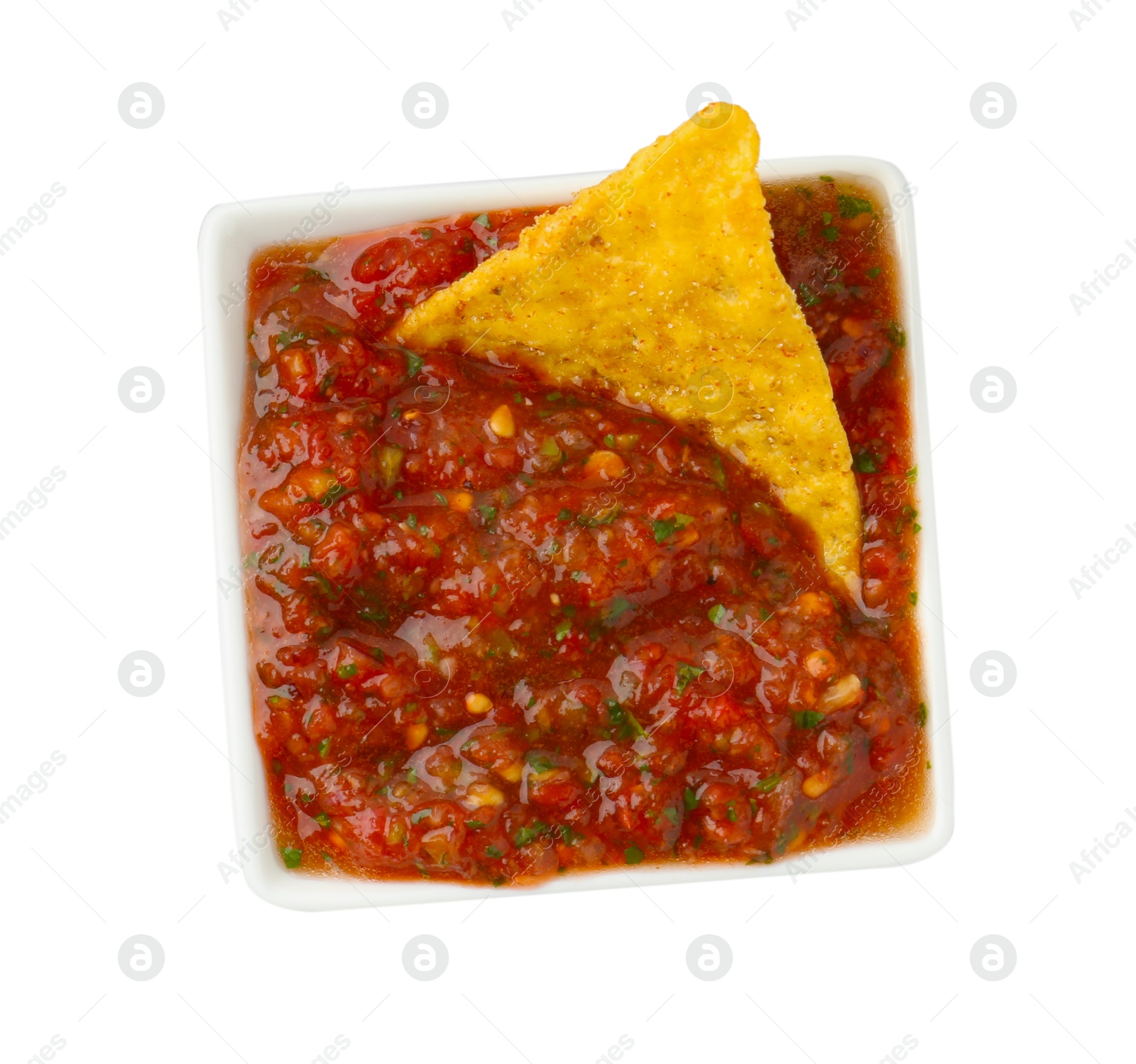 Photo of Tasty salsa sauce in bowl and tortilla chip isolated on white, top view