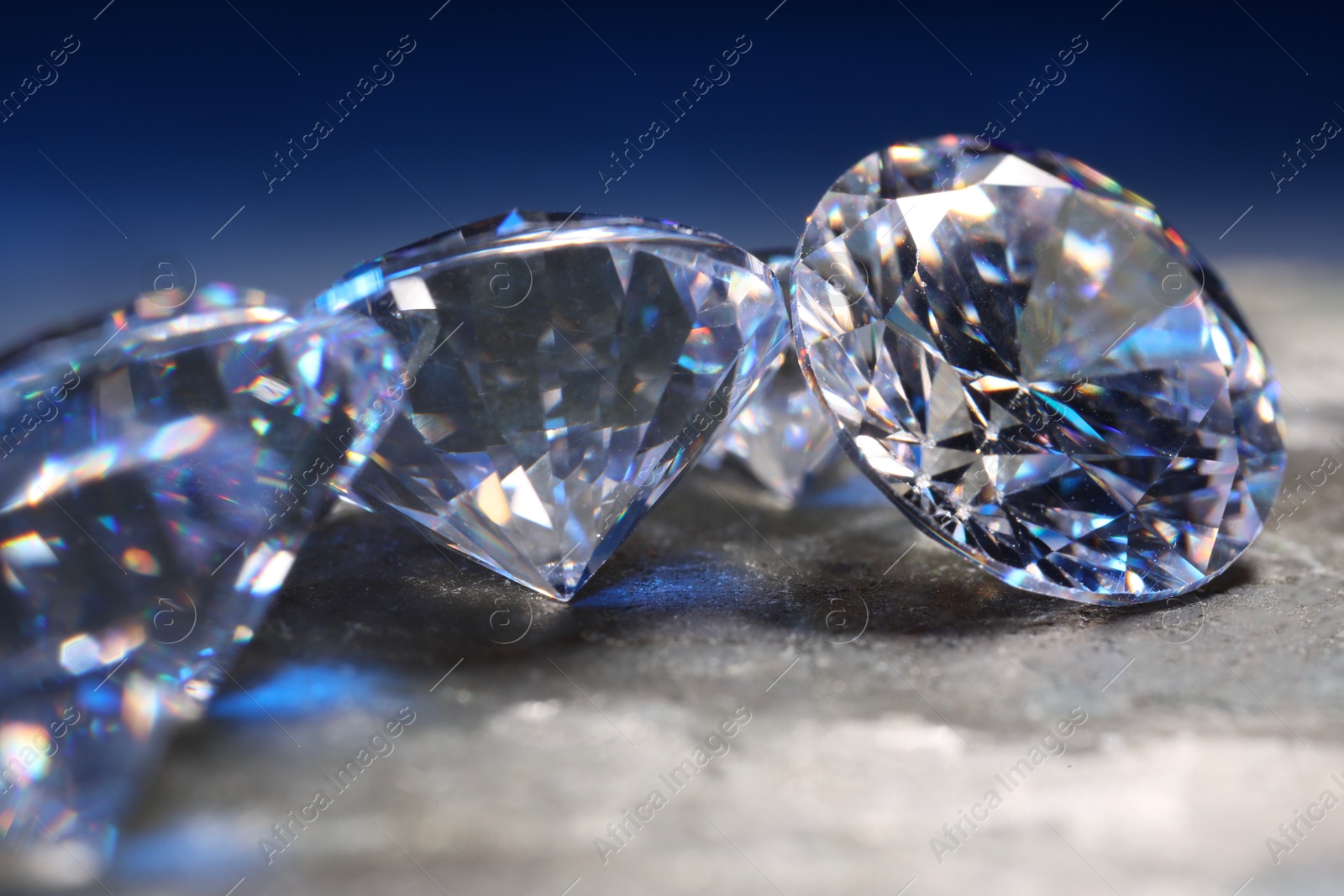 Photo of Beautiful shiny gemstones on stone, closeup view