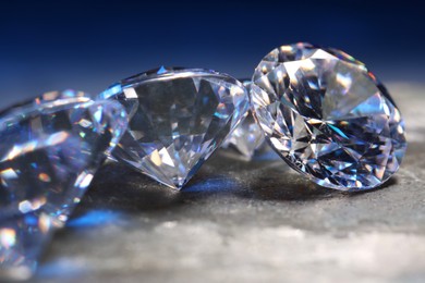 Photo of Beautiful shiny gemstones on stone, closeup view