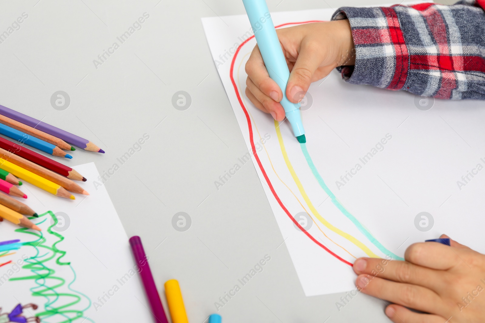 Photo of Boy drawing picture at light table, closeup