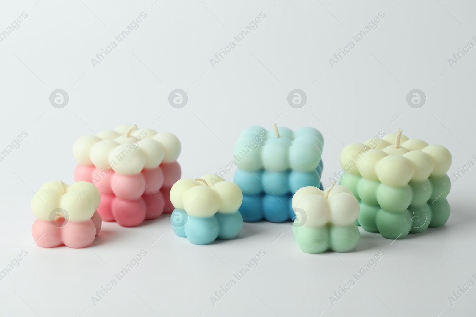 Photo of Many beautiful bubble candles on light background