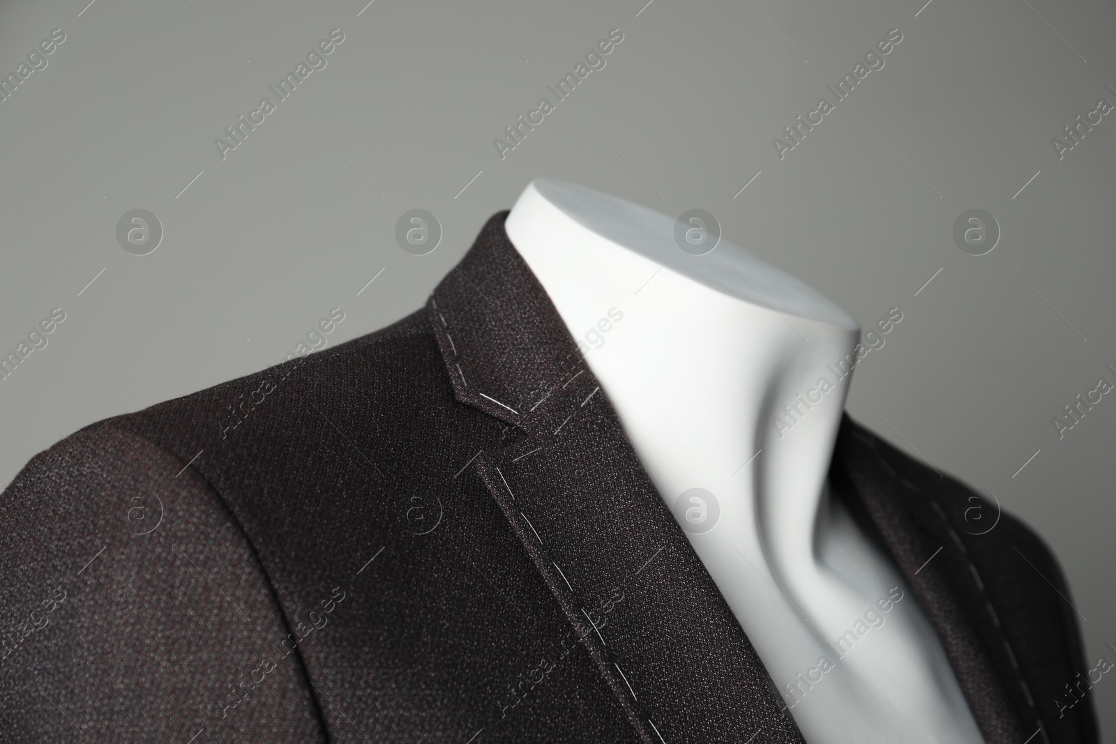 Photo of Semi-ready jacket on mannequin against grey background, closeup