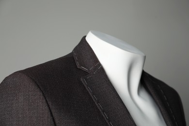 Photo of Semi-ready jacket on mannequin against grey background, closeup