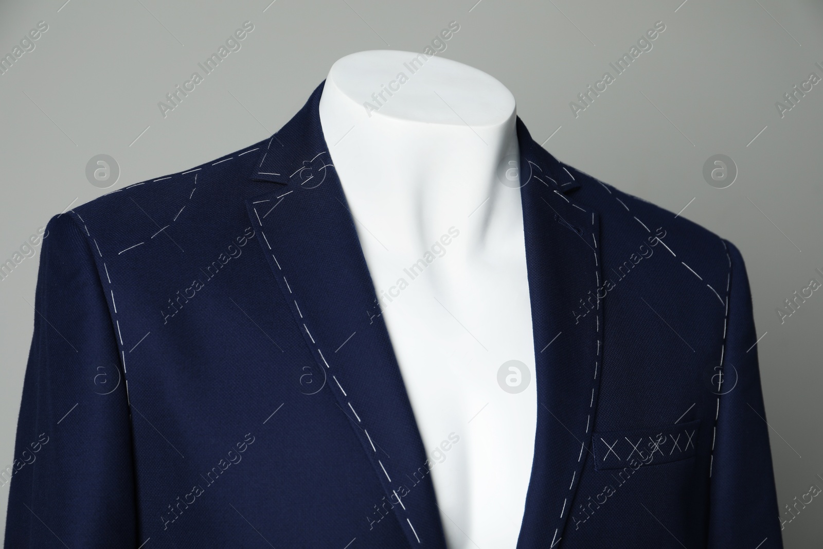 Photo of Semi-ready jacket on mannequin against grey background, closeup