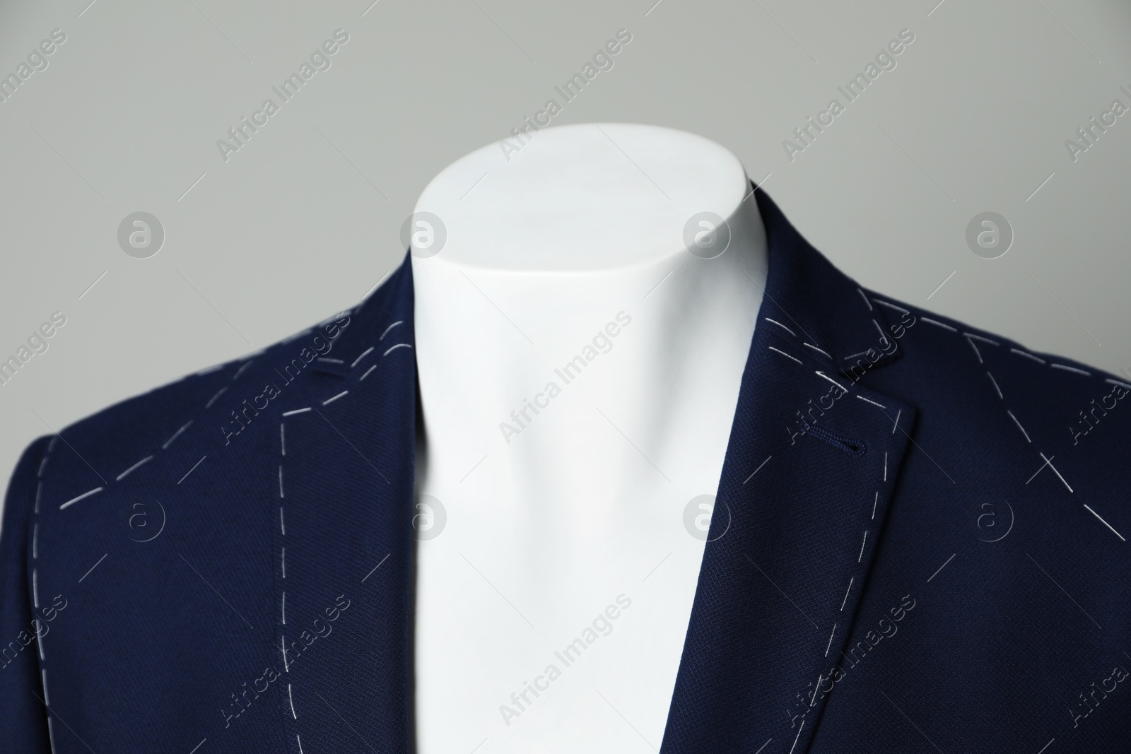 Photo of Semi-ready jacket on mannequin against grey background, closeup