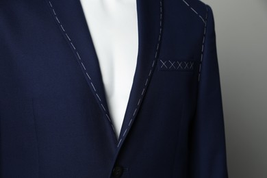 Photo of Semi-ready jacket on mannequin against grey background, closeup