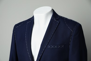 Photo of Semi-ready jacket on mannequin against grey background, closeup