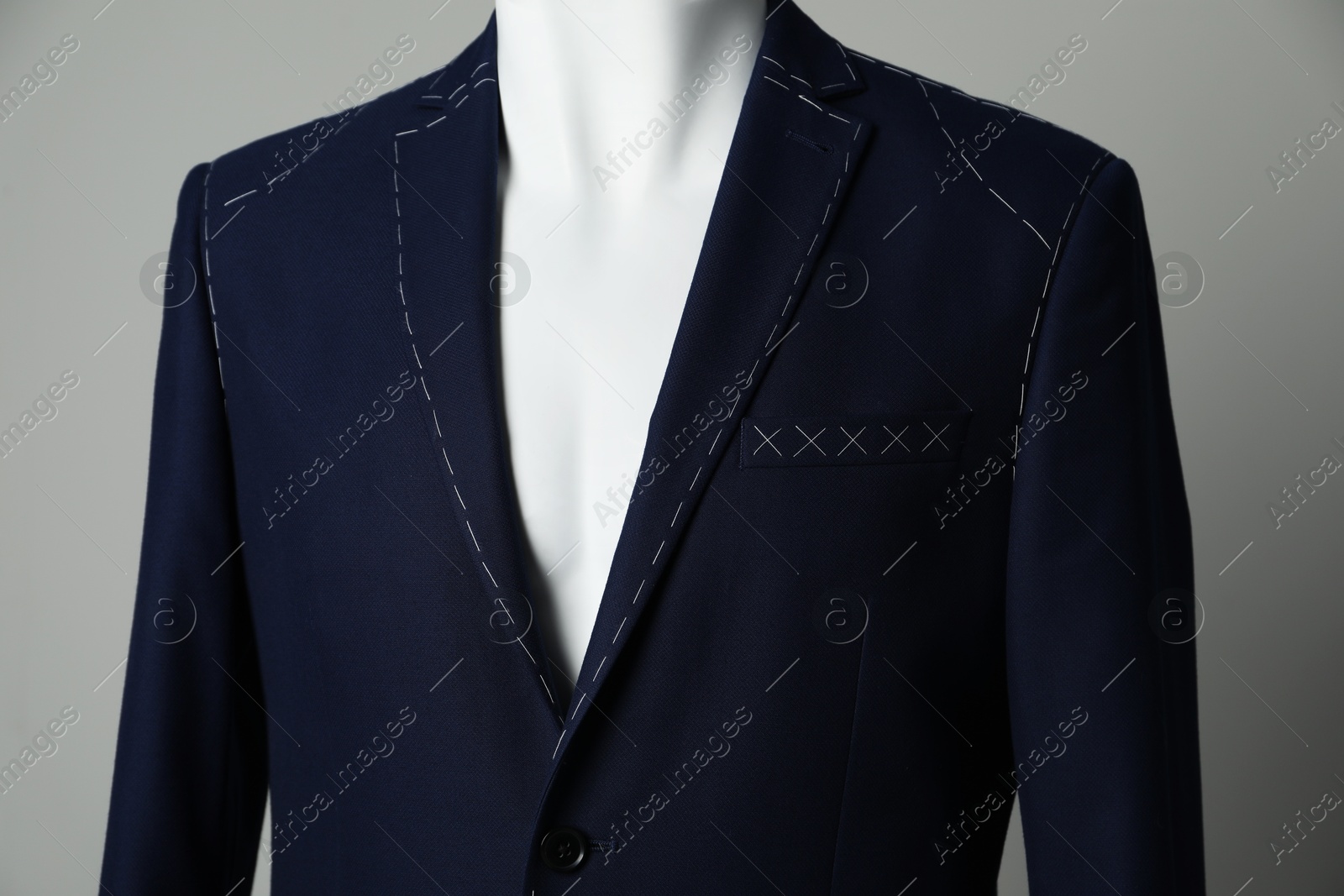 Photo of Semi-ready jacket on mannequin against grey background, closeup