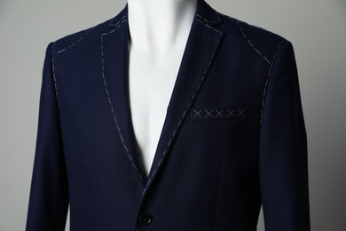 Photo of Semi-ready jacket on mannequin against grey background, closeup