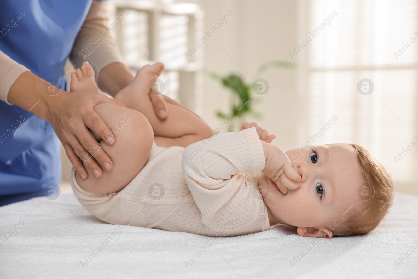 Photo of Pediatrician with little child in clinic, closeup. Checking baby's health