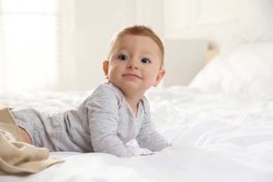 Photo of Cute little baby on bed at home