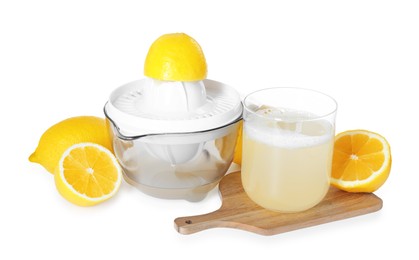 Photo of Fresh lemon juice in glass, juicer and fruits isolated on white