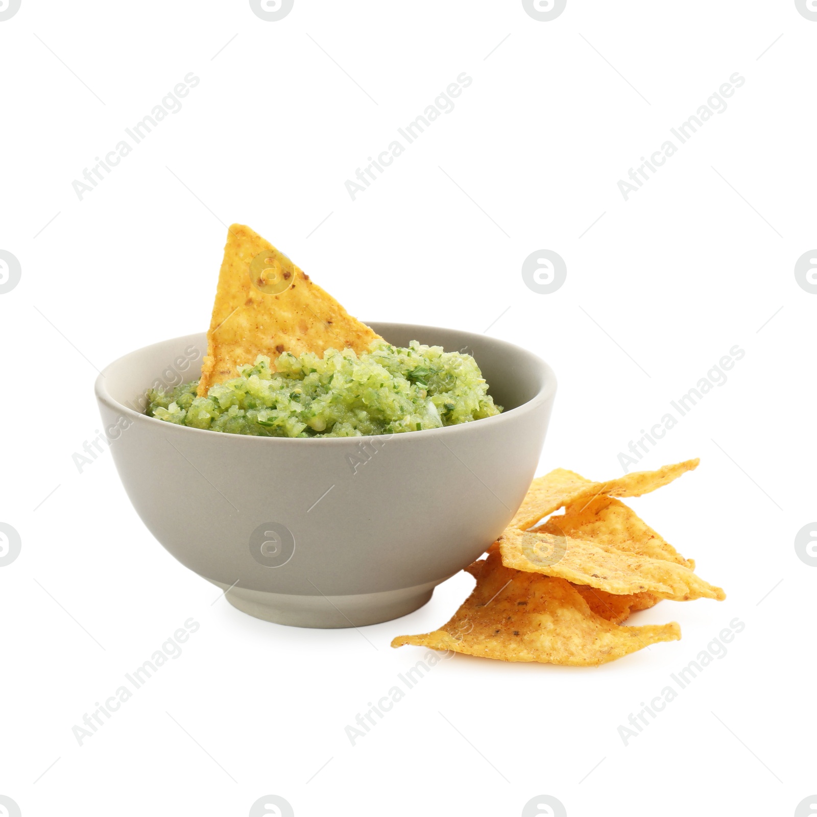 Photo of Delicious homemade green salsa with nachos isolated on white