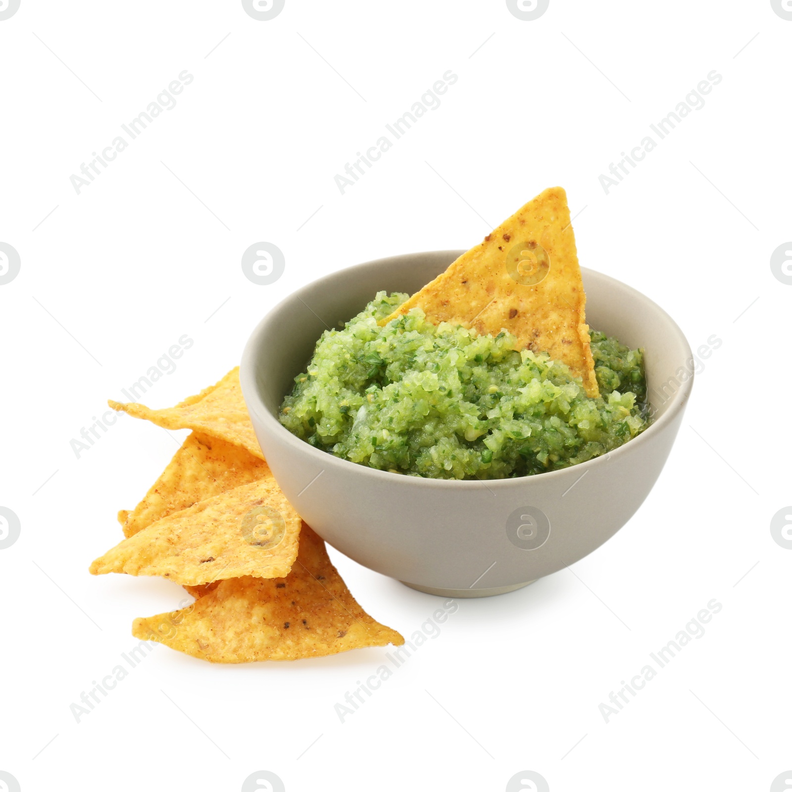 Photo of Delicious homemade green salsa with nachos isolated on white