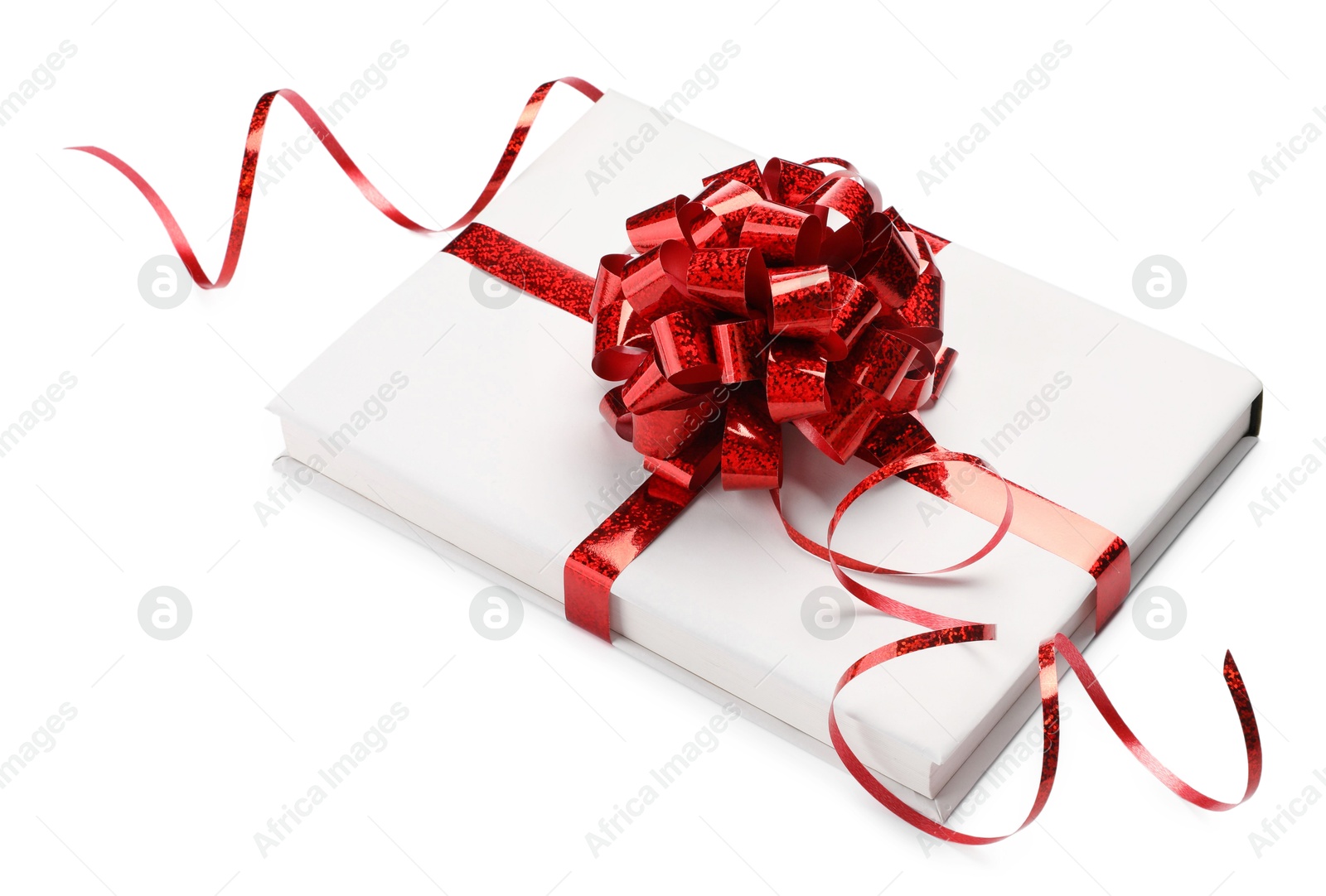 Photo of One book with red bow as gift isolated on white