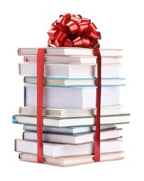 Photo of Stack of books with red bow as gift isolated on white