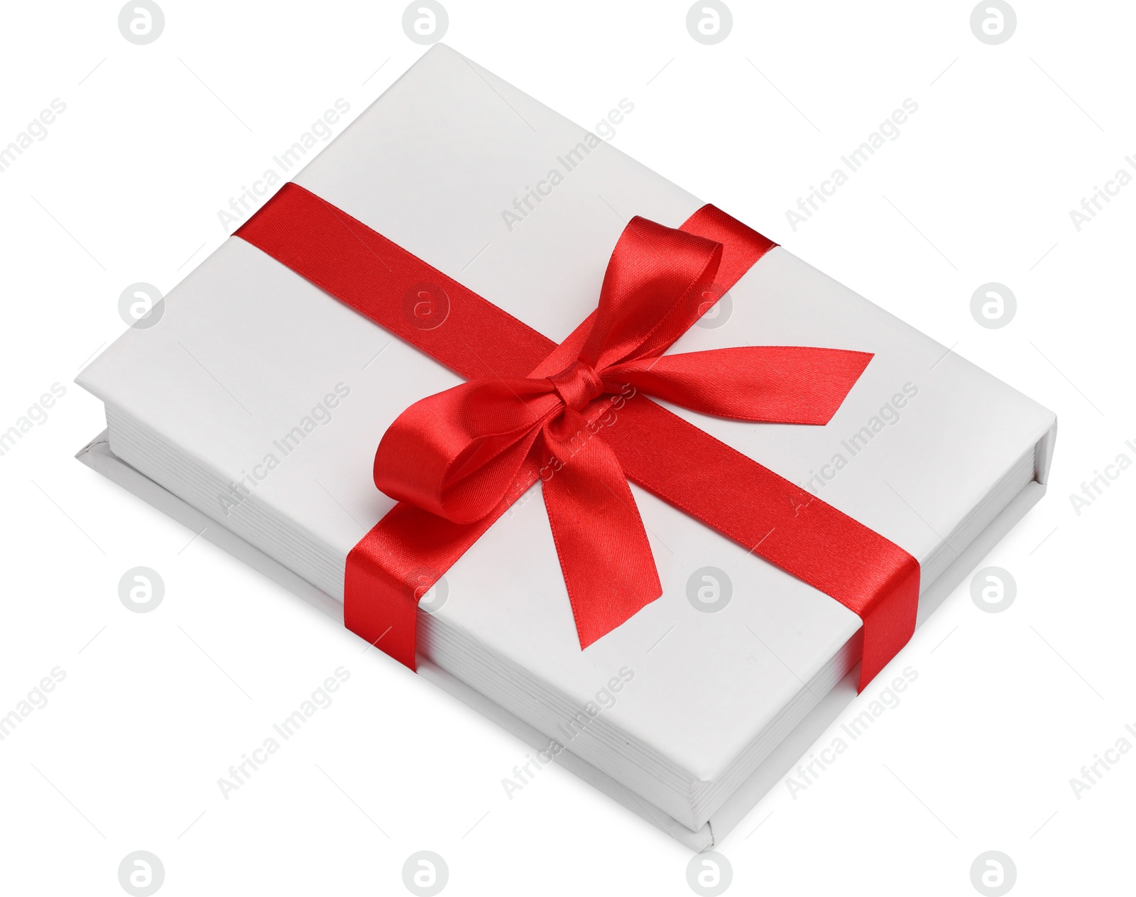 Photo of One book with red ribbon as gift isolated on white