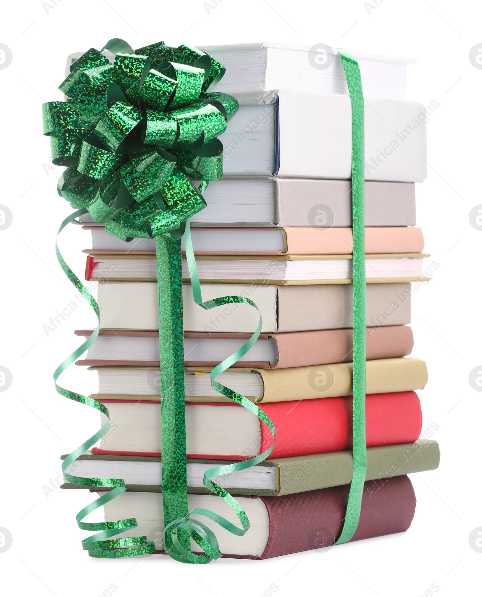 Photo of Stack of books with green bow as gift isolated on white