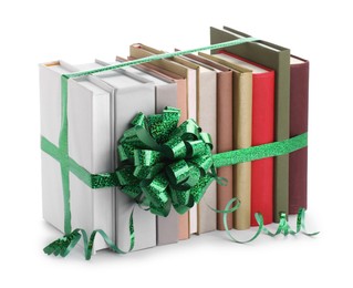 Photo of Many books with green bow as gift isolated on white