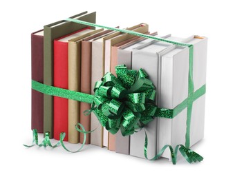 Photo of Many books with green bow as gift isolated on white