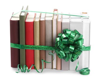 Photo of Many books with green bow as gift isolated on white