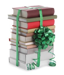 Photo of Stack of books with green bow as gift isolated on white