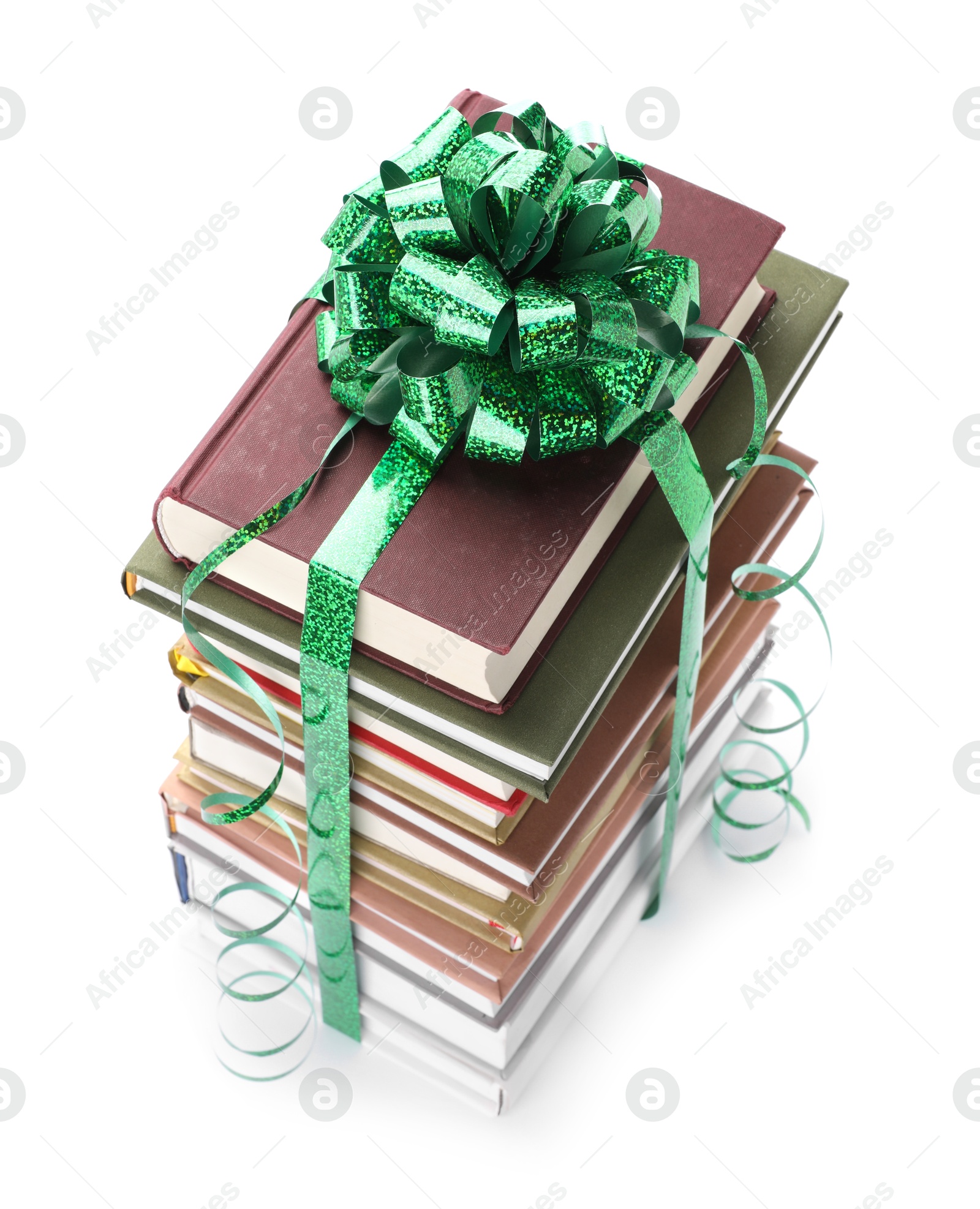 Photo of Stack of books with green bow as gift isolated on white