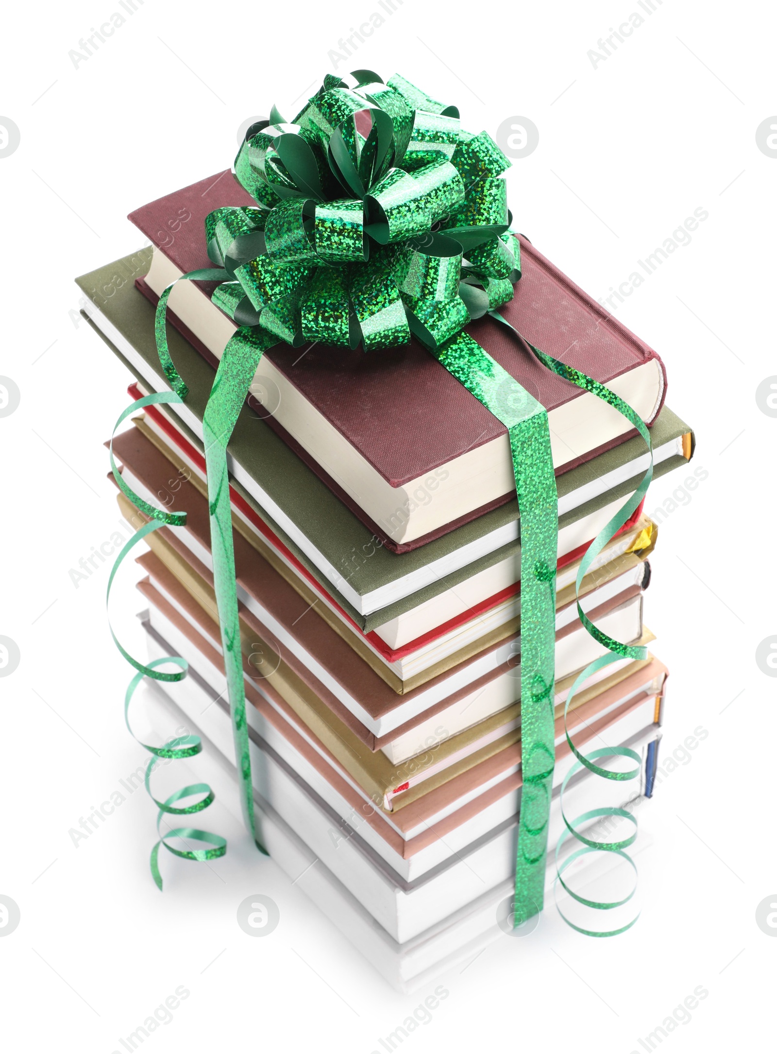 Photo of Stack of books with green bow as gift isolated on white