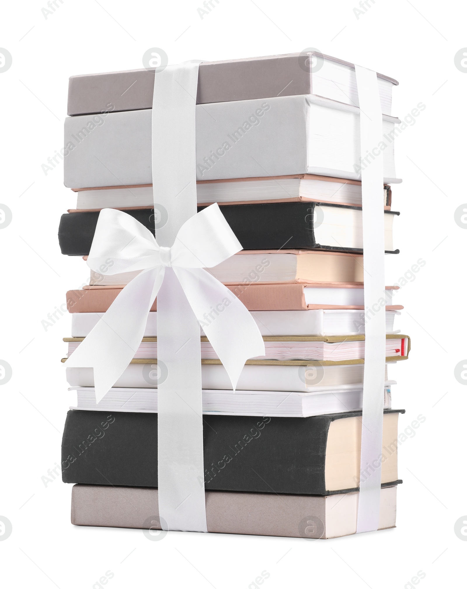 Photo of Stack of books with silk ribbon as gift isolated on white