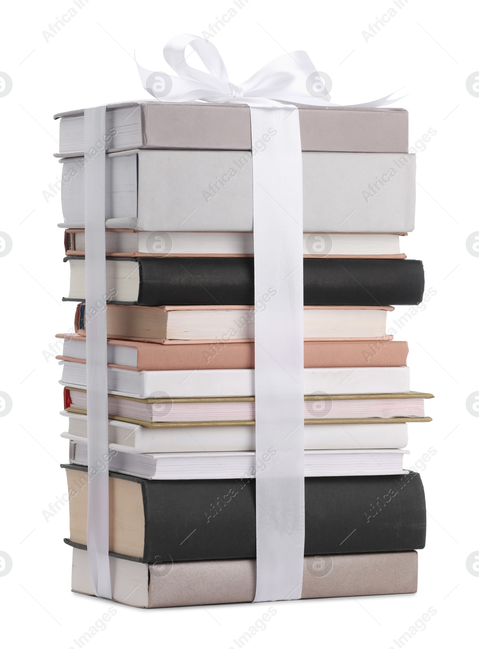 Photo of Stack of books with silk ribbon as gift isolated on white