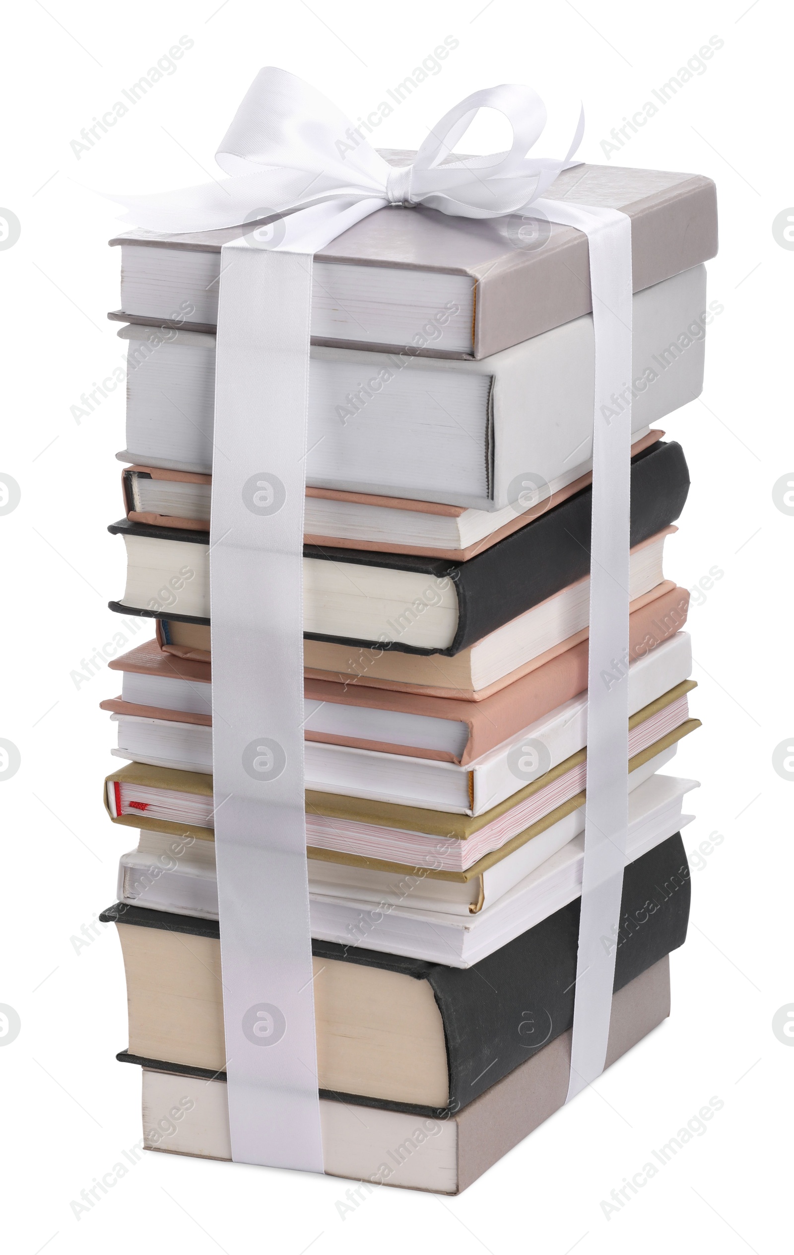 Photo of Stack of books with silk ribbon as gift isolated on white