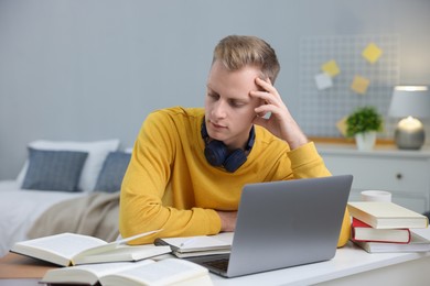 Photo of Student preparing for exam at table indoors