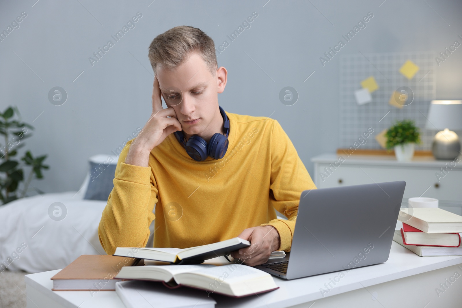 Photo of Student preparing for exam at table indoors