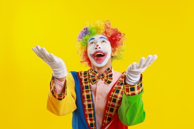 Photo of Portrait of happy clown on yellow background