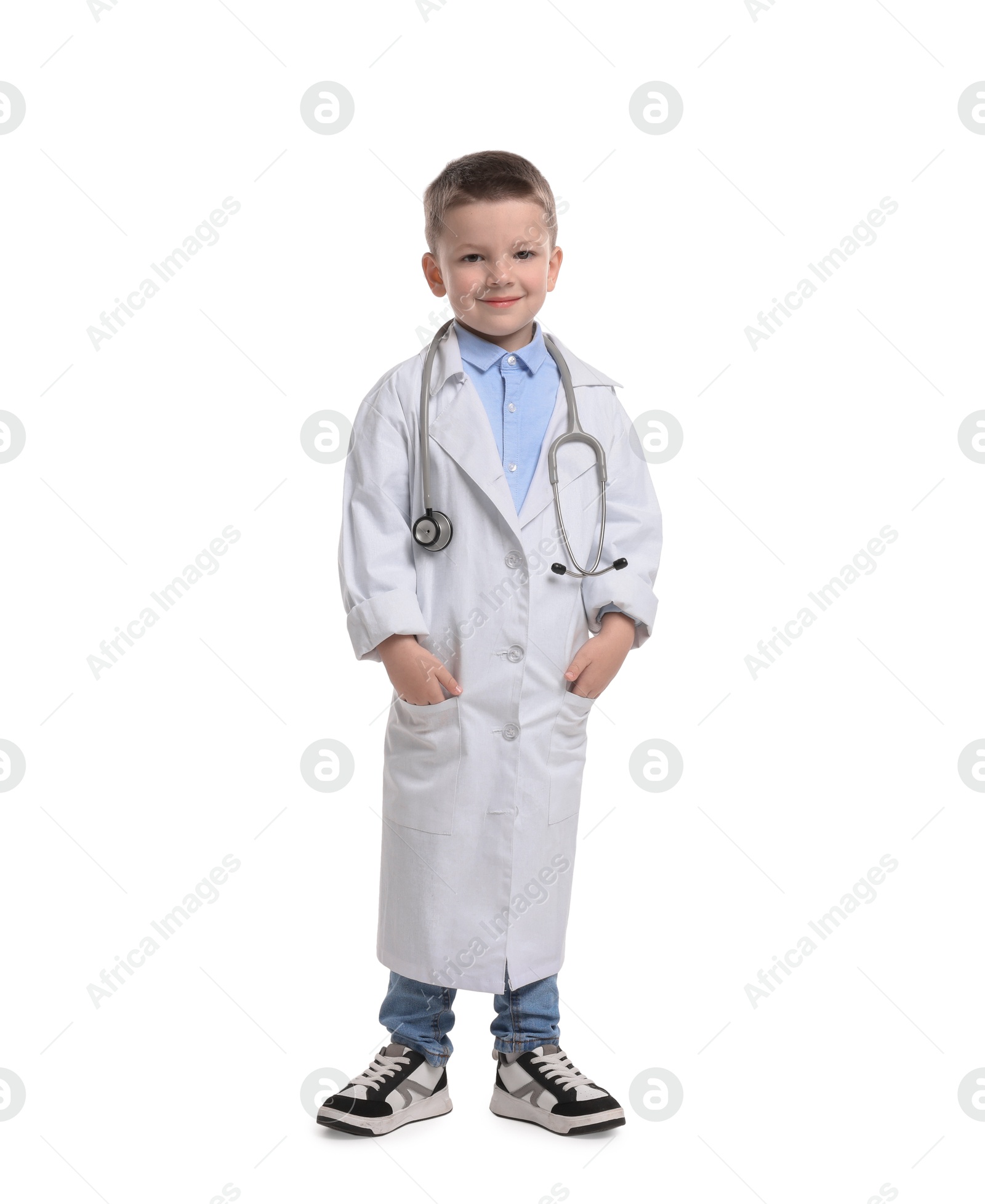 Photo of Little boy with stethoscope pretending to be doctor on white background. Dreaming of future profession