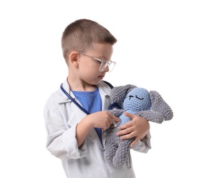 Photo of Little boy with stethoscope and toy pretending to be doctor on white background. Dreaming of future profession