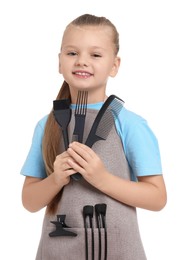 Photo of Little girl with brush and combs pretending to be hairdresser on white background. Dreaming of future profession