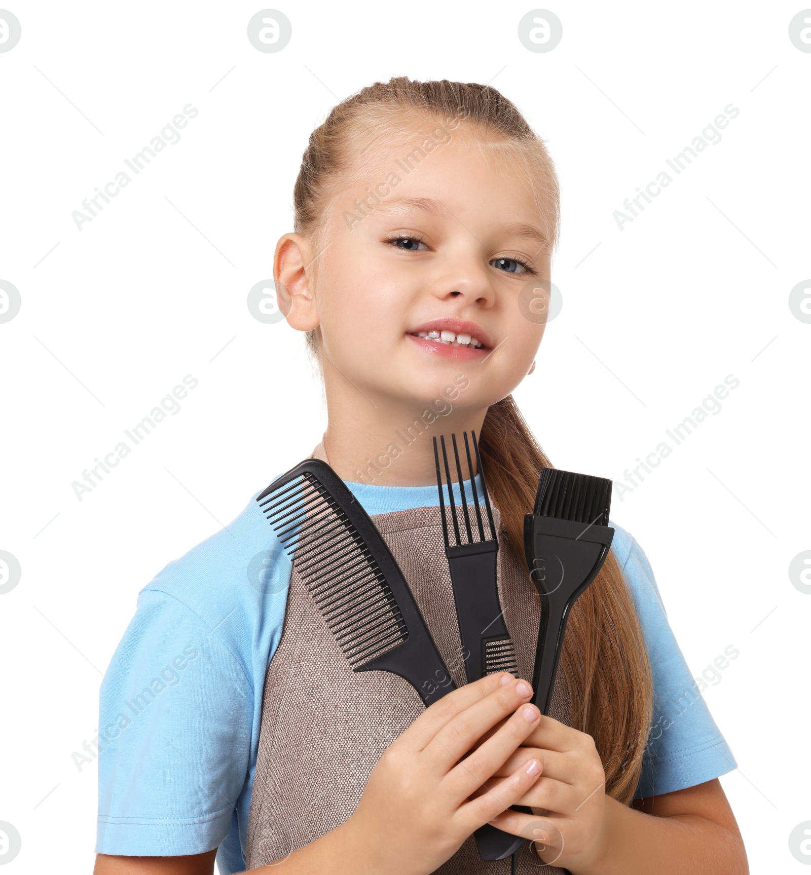 Photo of Little girl with brush and combs pretending to be hairdresser on white background. Dreaming of future profession