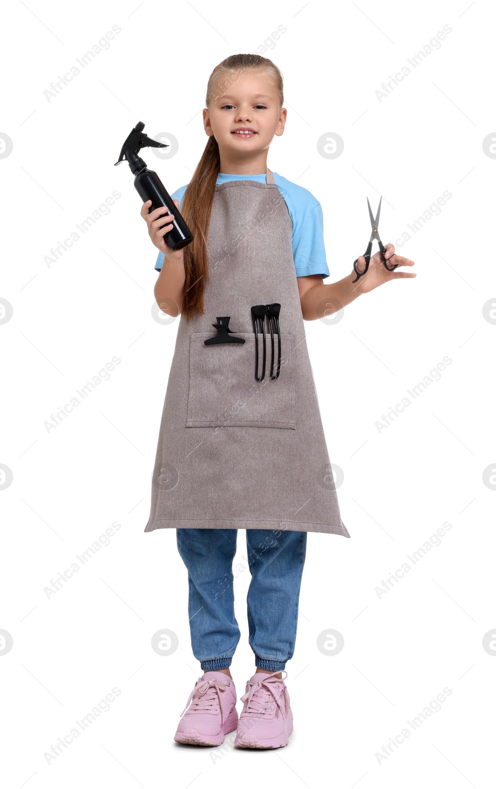 Photo of Little girl with scissors and sprayer pretending to be hairdresser on white background. Dreaming of future profession